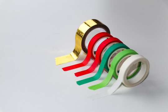 Christmas washi tape rolls red green gold on white background, festive craft decoration and gift wrapping supplies