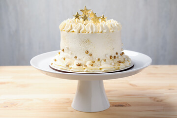 Delicious cake with Christmas decor on light wooden table