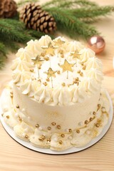 Delicious cake with Christmas decor on light wooden table, closeup