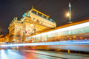 Light trails of tram next to the National Theatre in UNESCO world heritage site city Prague in night. 