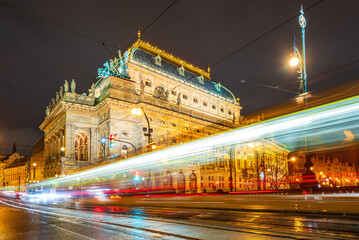 Light trails of tram next to the National Theatre in UNESCO world heritage site city Prague in night. 