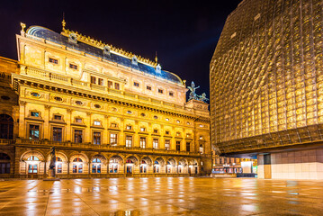 The illuminated National Theatre square in the UNESCO world heritage site city Prague in night after rain.