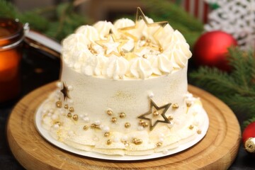 Delicious cake with Christmas decor on table, closeup