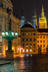 The historical lamppost on the Hradcanske Namesti and Prague castle in the background in UNESCO world heritage site Prague in Hradcany in night. 