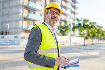 Construction engineer inspecting building site with worried expression
