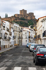 Corner with History: The Luna Castle dominating the perspective of a traditional street in Alburquerque.