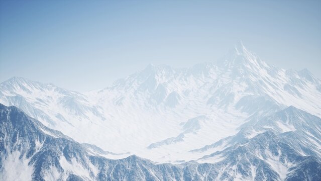 Vast range of snow clad mountains stretches across the horizon, illuminated by a clear blue sky. The tranquil landscape evokes a sense of peace and adventure in winter.