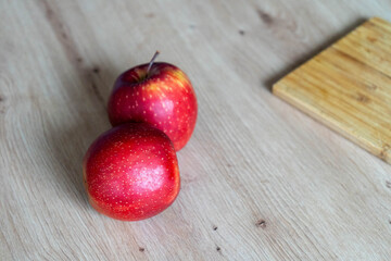 Fresh red apples on wooden table, natural organic fruit arranged for healthy eating and autumn harvest concept
