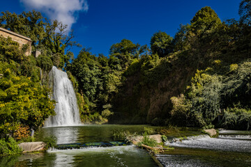 Fototapeta premium Isola del Liri, Frosinone, Lazio, Italy - The village, with its impressive waterfall in the historic center of the city. The river flows past the Boncompagni-Viscogliosi Castle, forming an island.