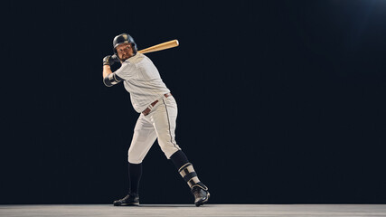 Baseball batter in ready stance focusing on pitch timing and reaction. Concept of anticipation and...