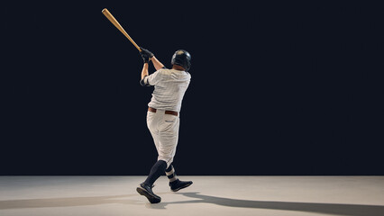 Baseball player finishing swing demonstrating momentum transfer and follow-through. Concept of...