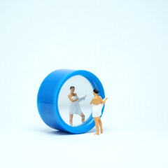 Mini toy of action figure at table with blurred background. Toy photography concept design. Businesswoman with mirror.