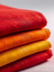 Close-up of colorful folded textiles showcasing vibrant fabric textures