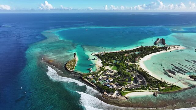 Aerial view of a resort Island, a vibrant contrast of turquoise waters, lush green vegetation, and white sandy beaches, Thulusdhoo, North Male Atoll, Maldives.