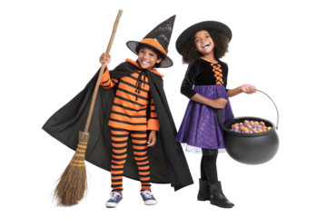 Young boy and girl in festive Halloween witch costumes stand smiling, holding a broom and a candy filled cauldron, excited for trick or treat fun.