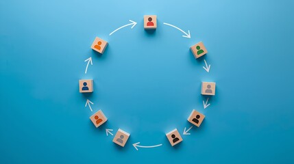A conceptual image representing teamwork and collaboration using blocks arranged in a circle with arrows symbolizing a continuous process. 