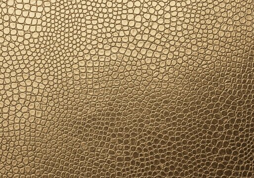 Luxury golden crocodile leather texture with embossed reptile skin pattern for a background