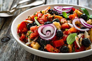 Panzanella salad on wooden table	