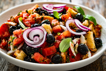 Panzanella salad on wooden table	