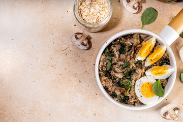 Tasty savory overnight oatmeal. Tasty non-sweet breakfast oats with spinach, mushrooms and eggs, on beige background ingredients for cooking