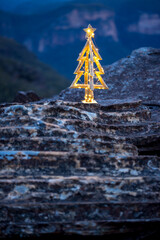 Christmas in Blue Mountains.  Decorated rustic timber Christmas Tree on a cliff in the Blue Mountains