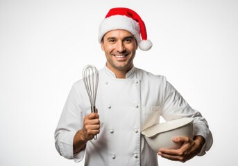 Naklejka premium Smiling chef in Santa hat holding a whisk and mixing bowl ready for holiday baking