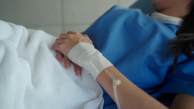 Woman patient sitting on hospital bed suffering stomach pain and diarrhea, feeling anxious about possible cancer and medical costs while waiting for diagnosis and treatment. Health insurance.
