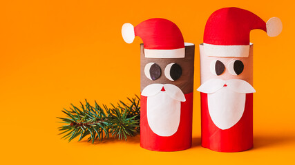 Christmas toy from toilet tube roll, paper toy santa claus, snowman, reindeer, tree rabbit on yellow background. Holiday easy kids DIY, decoration idea for winter season, home party. Children's crafts