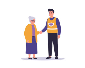 Caring young man in a volunteer vest gently holds the hand of an elderly woman offering support and companionship