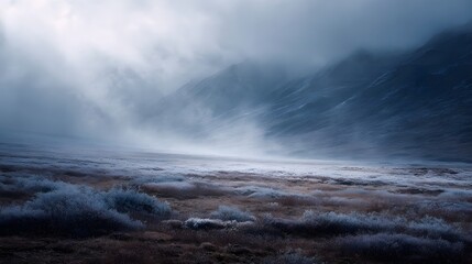Misty arctic landscape featuring frost covered tundra plains and dramatic mountains under a clouded dawn sky