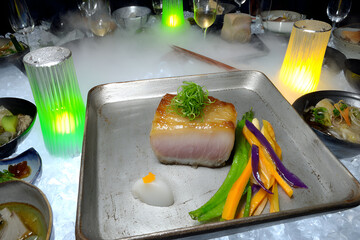 Refined Japanese fine dining features beautifully presented dish with fish, vegetables