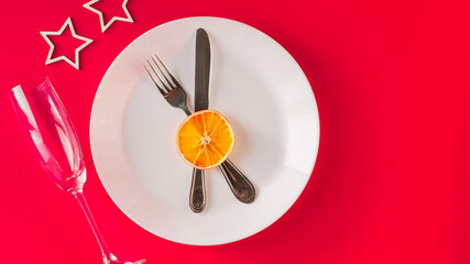 Christmas table setting for christmas dinner, served table with plate, gift, champagne glass, New year decorations. Flat lay, top view