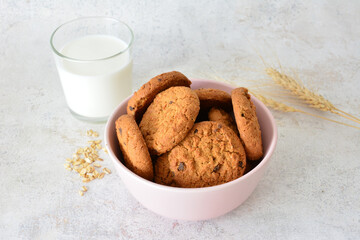 Delicious Oatmeal Cookies with a Glass of Fresh Milk decorated with ears of wheat