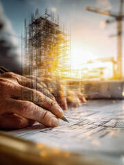 Architect?s hand drawing building plans with overlay of high-rise construction site during golden hour showcasing design and structural development process