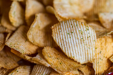 Close-up details of the seasoned wavy potato chips