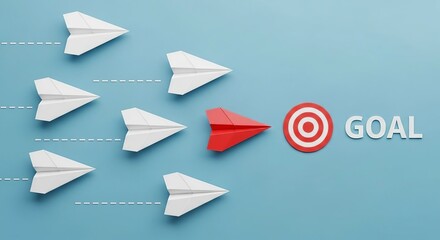 Red paper airplane leads others towards a target and the word goal