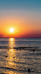 beautiful sunset over the blue sea waves