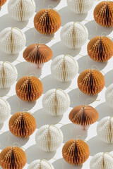 Neutral Paper Christmas Ornaments as round balls and one mushroom, hanging crafted eco-friendly New Year decorations. Minimal aesthetic holidays pattern, top view background of winter baubles