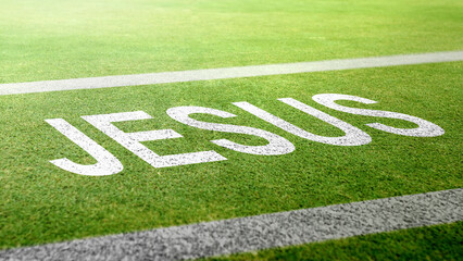 Obraz premium Text of Jesus on green grass texture. Concept of Christianity, religious, faith, Jesus, or belief