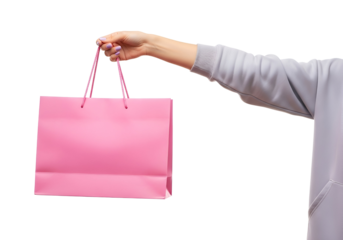 Female hand holding a bright pink shopping bag with vibrant purple nails, perfect for retail, gift, and sale concepts, isolated on transparent background.