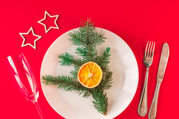 Christmas table setting for christmas dinner, served table with plate, gift, champagne glass, New...