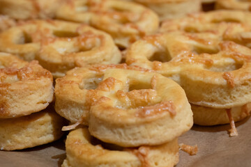 Freshly baked cheese pastries on parchment paper
