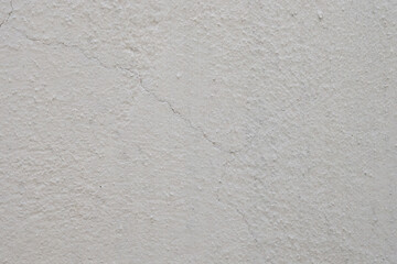 Cracked white plaster wall texture
