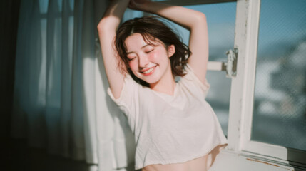 Smiling woman enjoying fresh morning sunlight with relaxed and positive mood