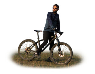 Obraz premium Cyclist in shorts and jersey on a modern carbon hardtail bike with an air suspension fork standing on a cliff against the background of fresh green spring forest