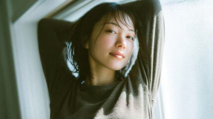 Smiling woman enjoying fresh morning sunlight with relaxed and positive mood