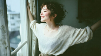 Smiling woman enjoying fresh morning sunlight with relaxed and positive mood