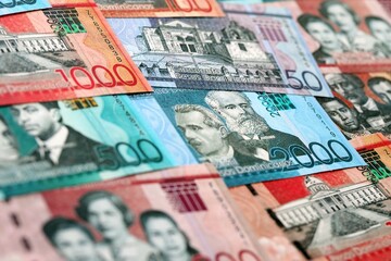 Dominican Republic Pesos currency money bills. DOP currency banknotes in bunch with different denomination close up