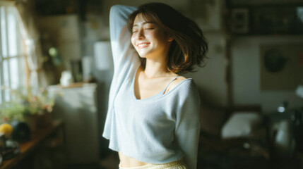 Smiling woman enjoying fresh morning sunlight with relaxed and positive mood