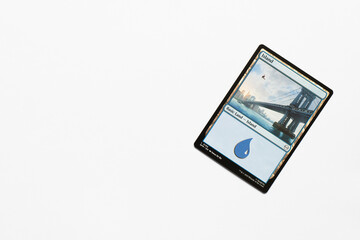 Obraz premium Bradford, UK Nov 3 2025 Basic Land Island Spider-man card magic the gathering card shot isolated on a white paper background.